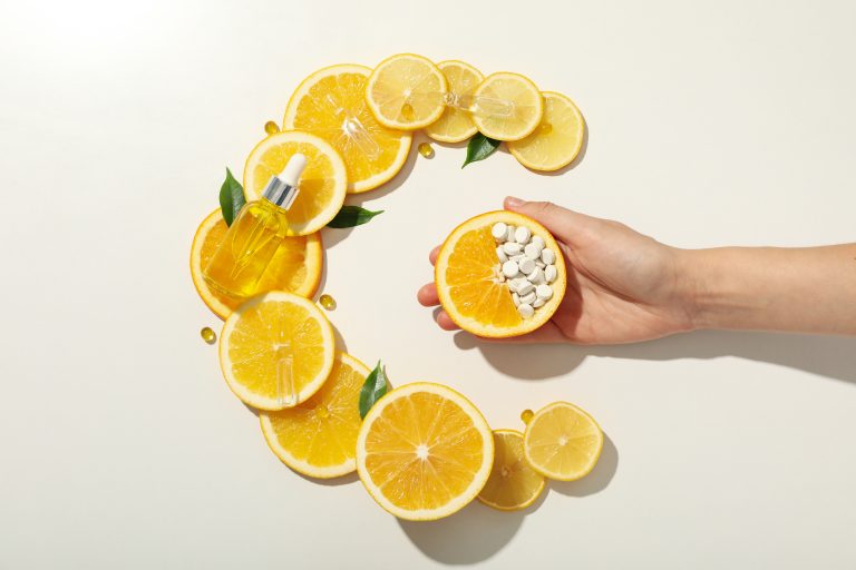 Vitamin C in liquid serum with citrus fruits